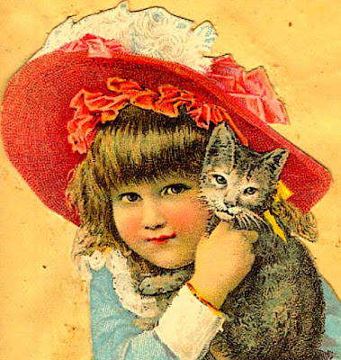 blond girl with large red & white bonnet cuddles gray kitten with white markings on face