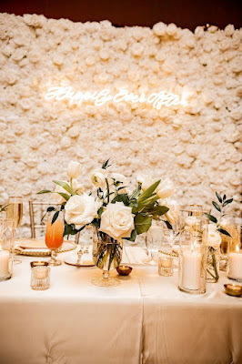 floral centerpiece with white rose backdrop