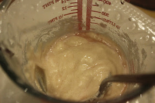 Home-made Royal icing adding liqueur