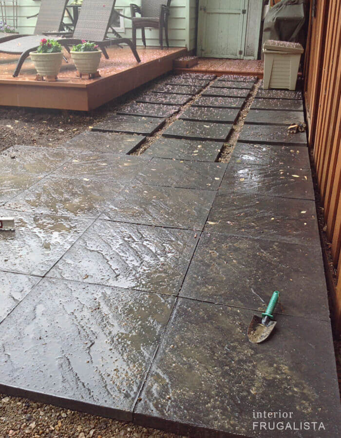 A DIY gray slate paver block patio for a small gazebo.