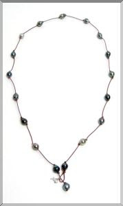 Tahitian pearls anchored on knotted mocha leather