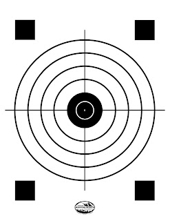 Circular target with a cross and black squares.