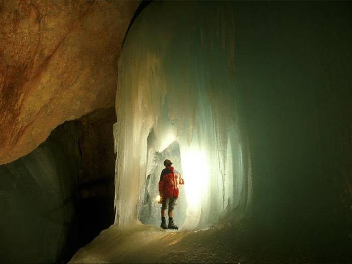 The Eisriesenwelt (German for "World of the Ice Giants") is a natural limestone ice cave located in Werfen, Austria, about 40 km south of Salzburg. The cave is inside the Hochkogel mountain in the Tennengebirge section of the Alps. It is the largest ice cave in the world, extending more than 42km and visited by about 200,000 tourists every year.