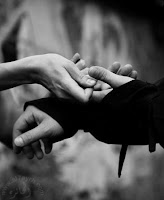 black and white photo of hands holding hands