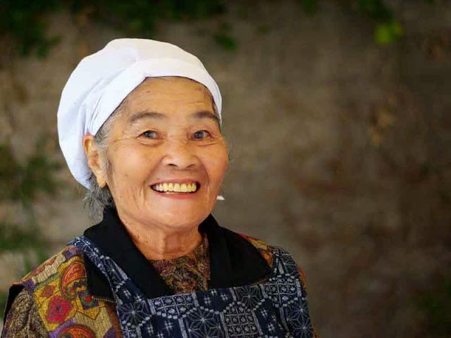 An elderly Okinawan woman working at a festival