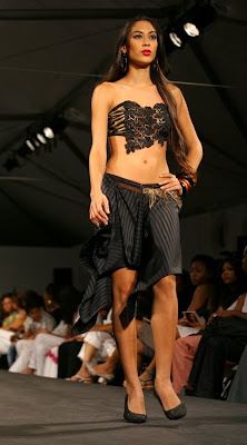 Guipure lace bandeau top with tiger and snake detailing and low-rise black skirt.