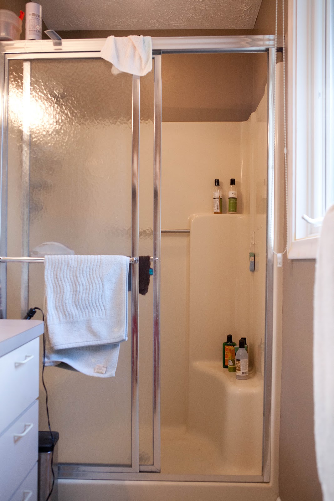 frameless shower enclosures BEFORE: Molded fiberglass shower stall with sliding glass doors.