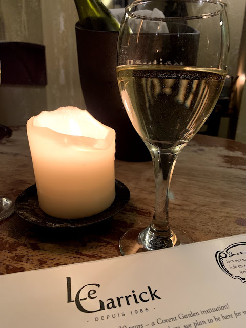 wine, candle and Le Garrick menu header