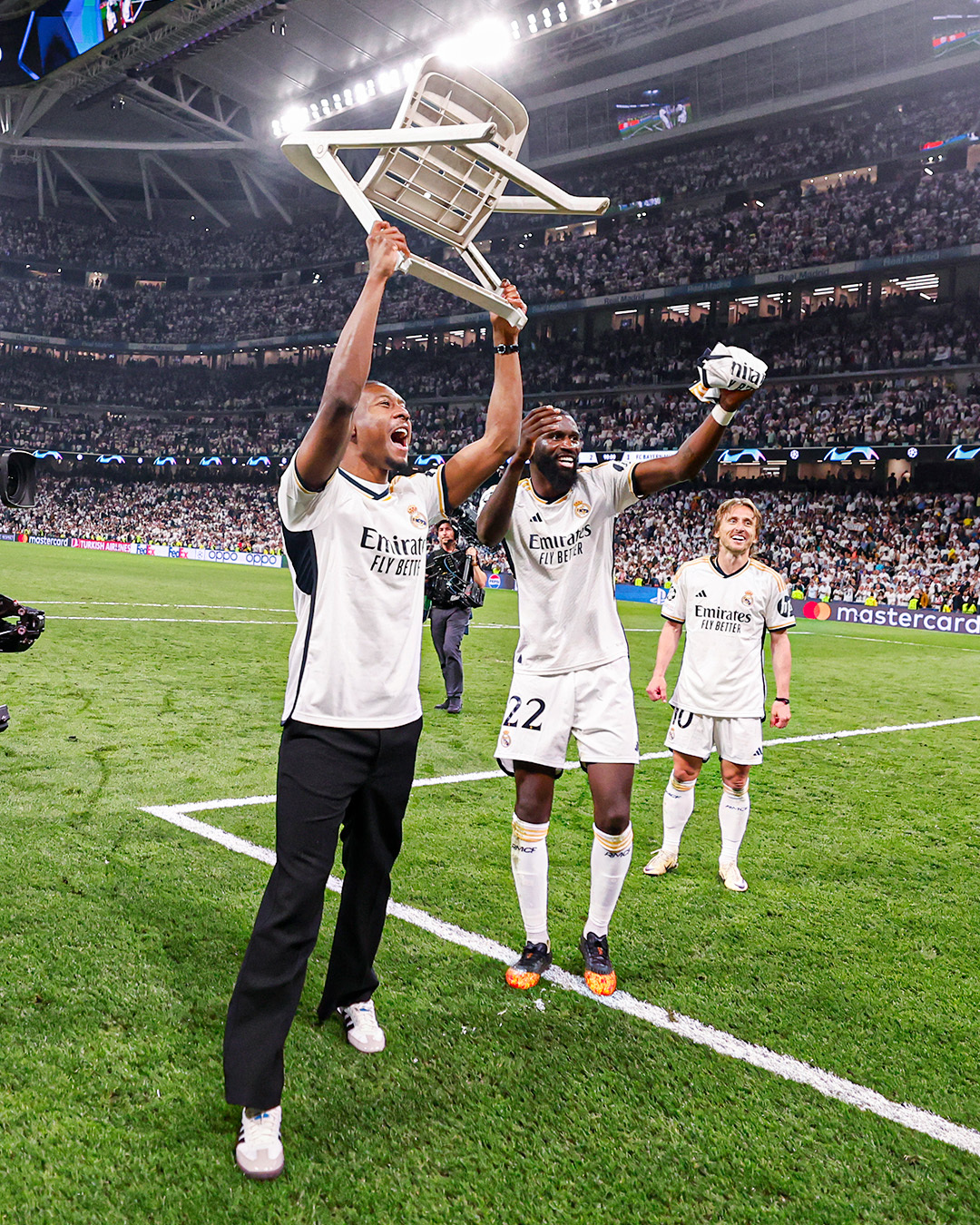 Real Madrid players take a shot in celebration of their progress into the final of the Uefa Champions League 2023/24 following their triumph over Bayern Munich in the semi final