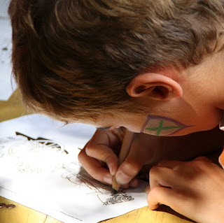 Boy filling in an activity sheet