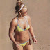 Britney Spears in a tiny yellow bikini in beach.