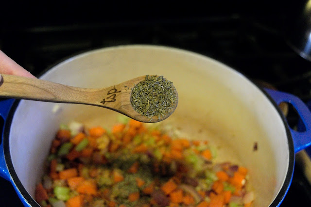 Dried thyme being added to the pot as well.