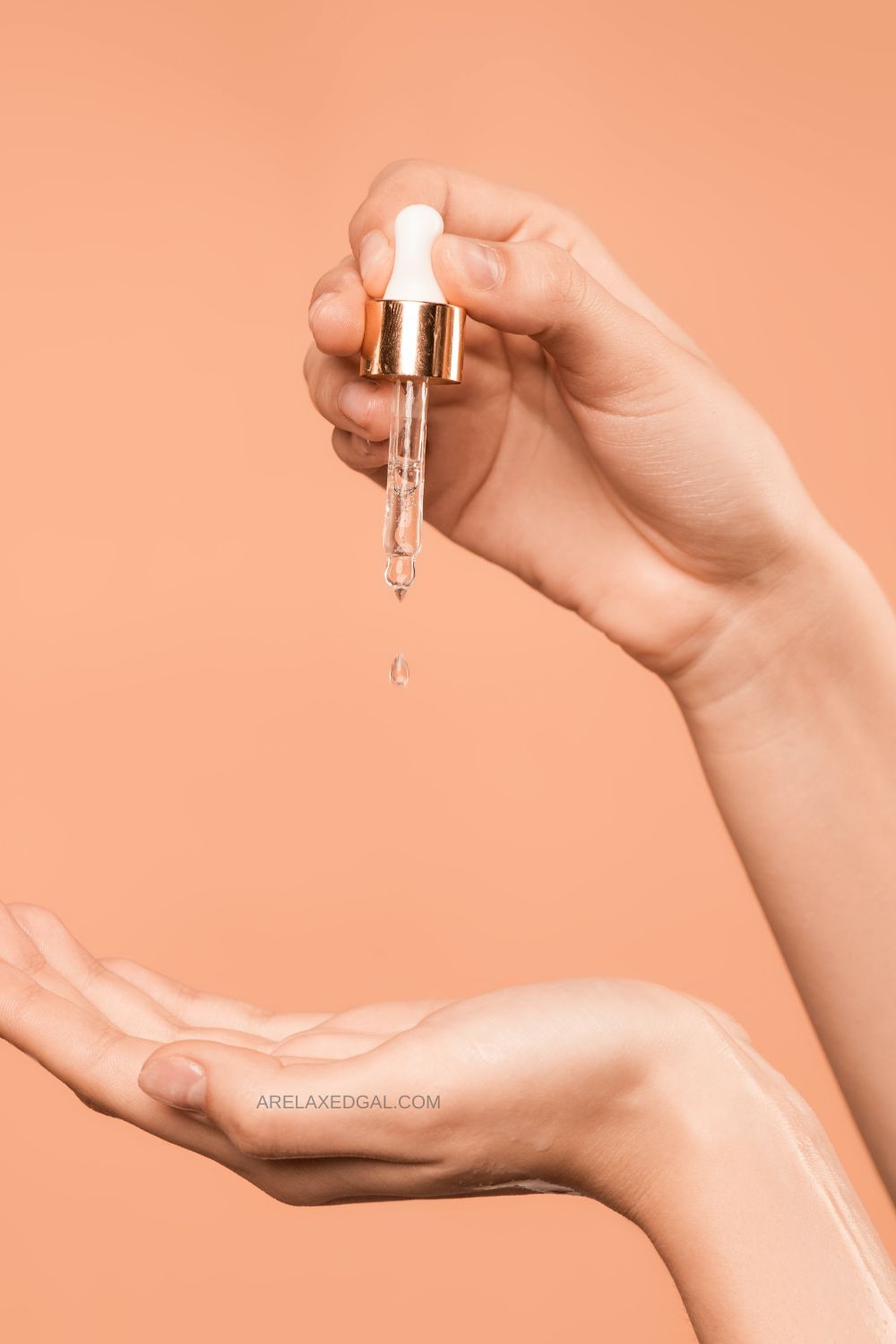 one hand using an oil dropper to get drops of oil on open hand to be used for scalp oiling