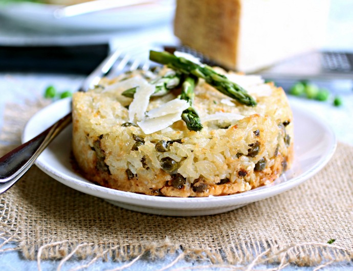 Recipe for a baked rice dish flavored with Parmesan cheese, fresh asparagus and peas.