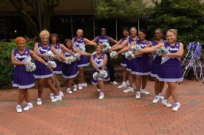 Group of cheerleaders posing in uniforms