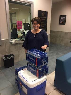 Cindy poses with cooler and water at the Apex Police Station