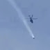 Helicopter Chasing UFO Emitting Smoke Flying Low And Fast