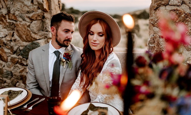 bohemian bride with hat and lace dress candlelight