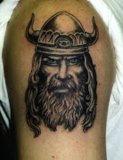 Picture of a colorrich viking tattoo featuring a blonde headed man with . (viking tattoo )