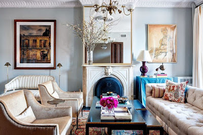 Great example of Victorian interior design for living room features gray wall, tufted sofa with cushions and black coffee table