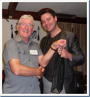 Club President, Gordon Sutherland, handing Andy Keys a thank you gift for his inspiring concert. Photo courtesy of Club Secretary, Colleen Kerr.