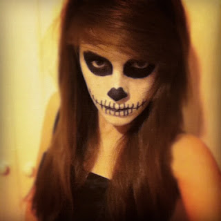 My dead ballerina makeup look, featuring another skull-like makeup look, with black eyes and skeleton nose and mouth, staring hauntingly into the camera.
