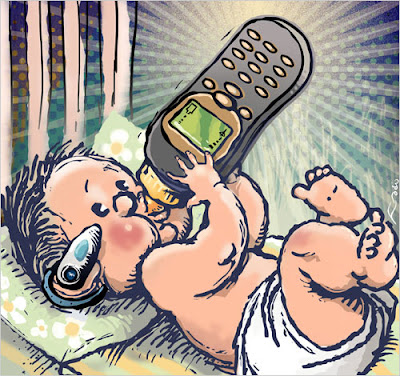 small baby holding a cell phone bottle