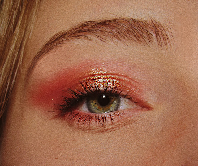 Woman with pink and gold eyeshadow close up