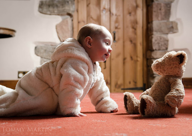 Young baby playing with teddy bear, shot by Tommy Martin, for Sprayway