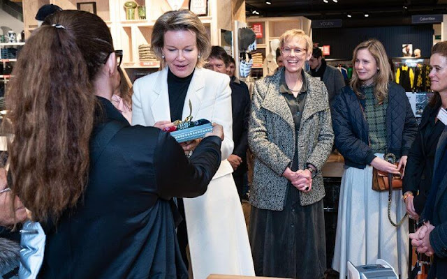 Queen Mathilde wore a new white cashmere long midi coat by Giorgio Armani, and black turtleneck sweater and black trousers
