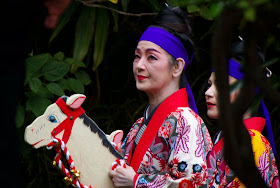 women dance, riding wooden horses