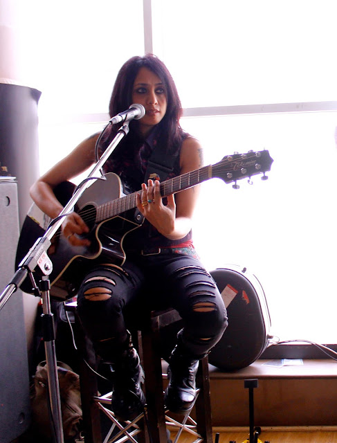 Teesta Galway performing with her guitar 