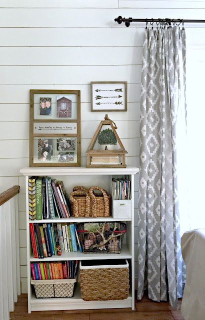 Ikea Billy bookshelf with trim added in front of plank wall with Target Aztec drapery panels - www.goldenboysandme.com