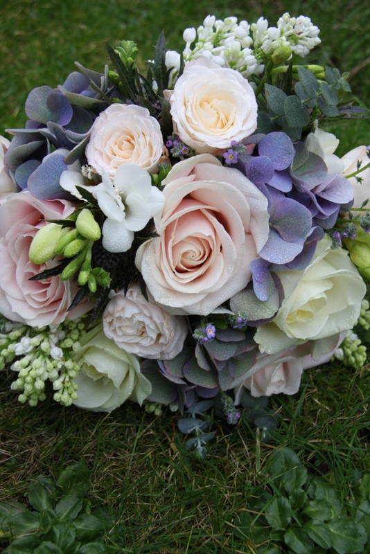 A gorgeous Vintage Pink Blue wedding bouquet in lovely spring blooms 