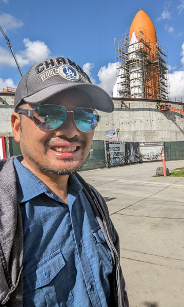 At the California Science Center in Los Angeles, a selfie is taken with Endeavour's Space Shuttle Stack as it stands tall inside the construction site for the Samuel Oschin Air and Space Center...on February 2, 2024.