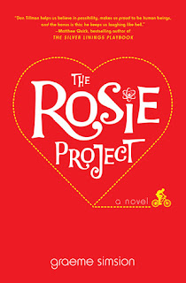 Rosie Project book cover (the "i" in "Rosie" is dotted with an atom, as a man on a bicycle rides in a heart-shaped line around the title, on a solid red background)