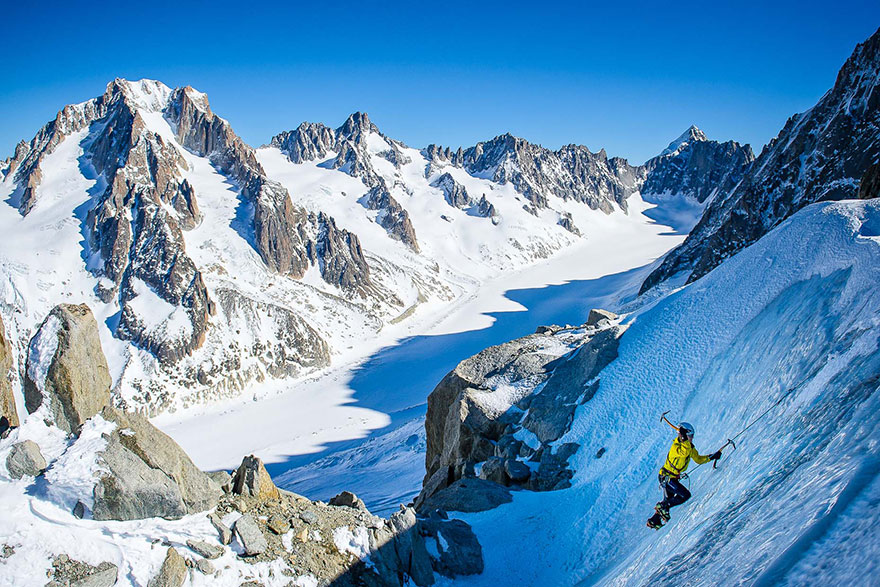 A lone mountaineer in a small ice cave - A Postcard With Adrenaline: I Photograph Hikers Climbing The Alps