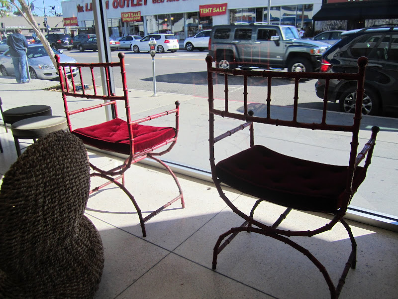 1950's vintage red metal faux bamboo chair in the window of Emmerson Troop