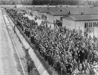 photo of dachau survivors lining up to welcome American soldiers