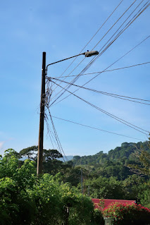 new street light on cement pole on dirt road in Puriscal