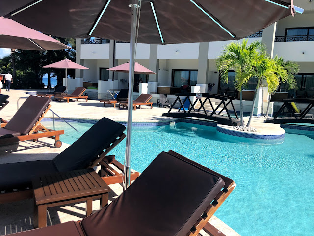 A view of the pool deck and pool, looking back at the resort building.