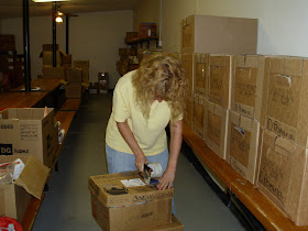 Lisa packing boxes of school supplies