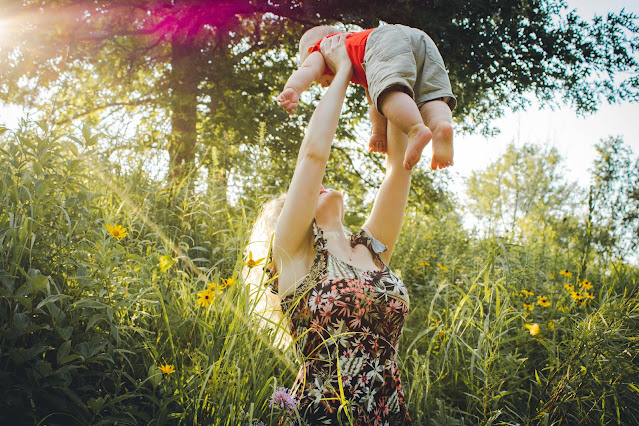 https://www.pexels.com/photo/mother-lifting-her-baby-1261909/