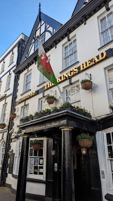 Kings Head Hotel, Monmouth (Wales) facade with entrance cover and Welsh flag.