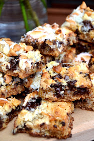 Magic bars - biscuit base, topped with walnuts, chocolate chunks, white chocolate chips, butterscotch bits, desiccated coconut, condensed milk and mini marshmallows.