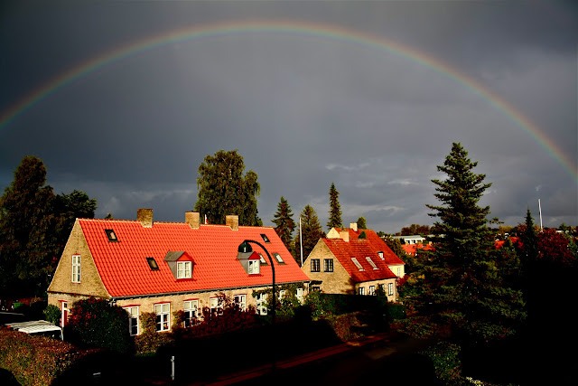 Rainbow on a beautiful blue sky over Copenhagen (København) taken from Hellerup. Rainbow at the same time as sunlight.