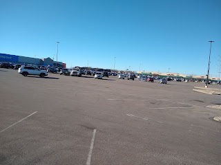 Big-box store parking lot, few cars