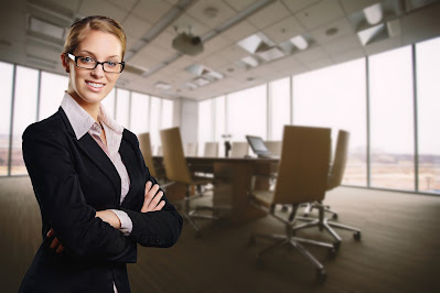 a lady standing in some type of meeting room