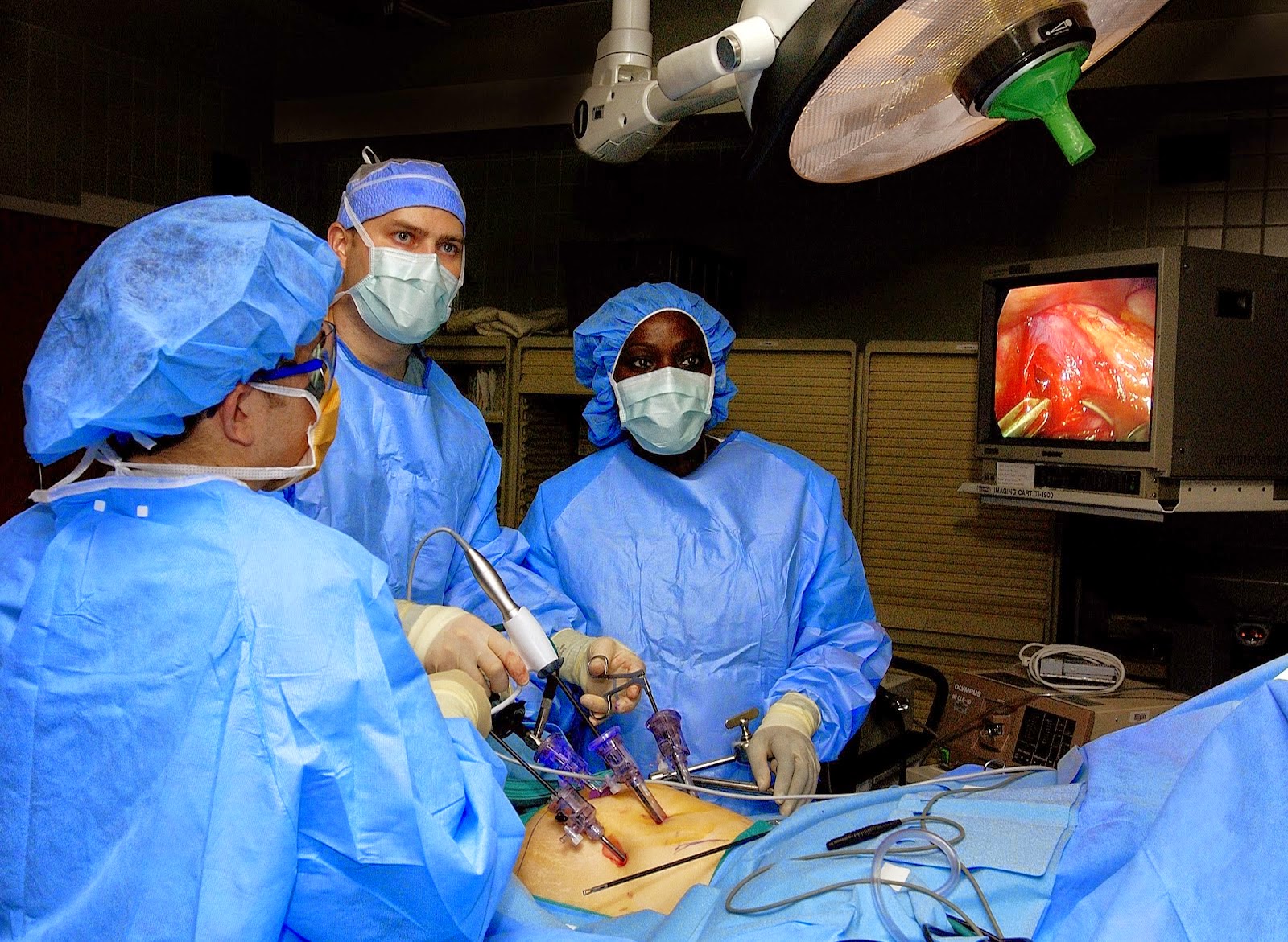 Surgeons performing bariatric surgery to a patient.