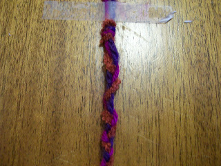 Three-plait, simple braid, in three colors of yarn.